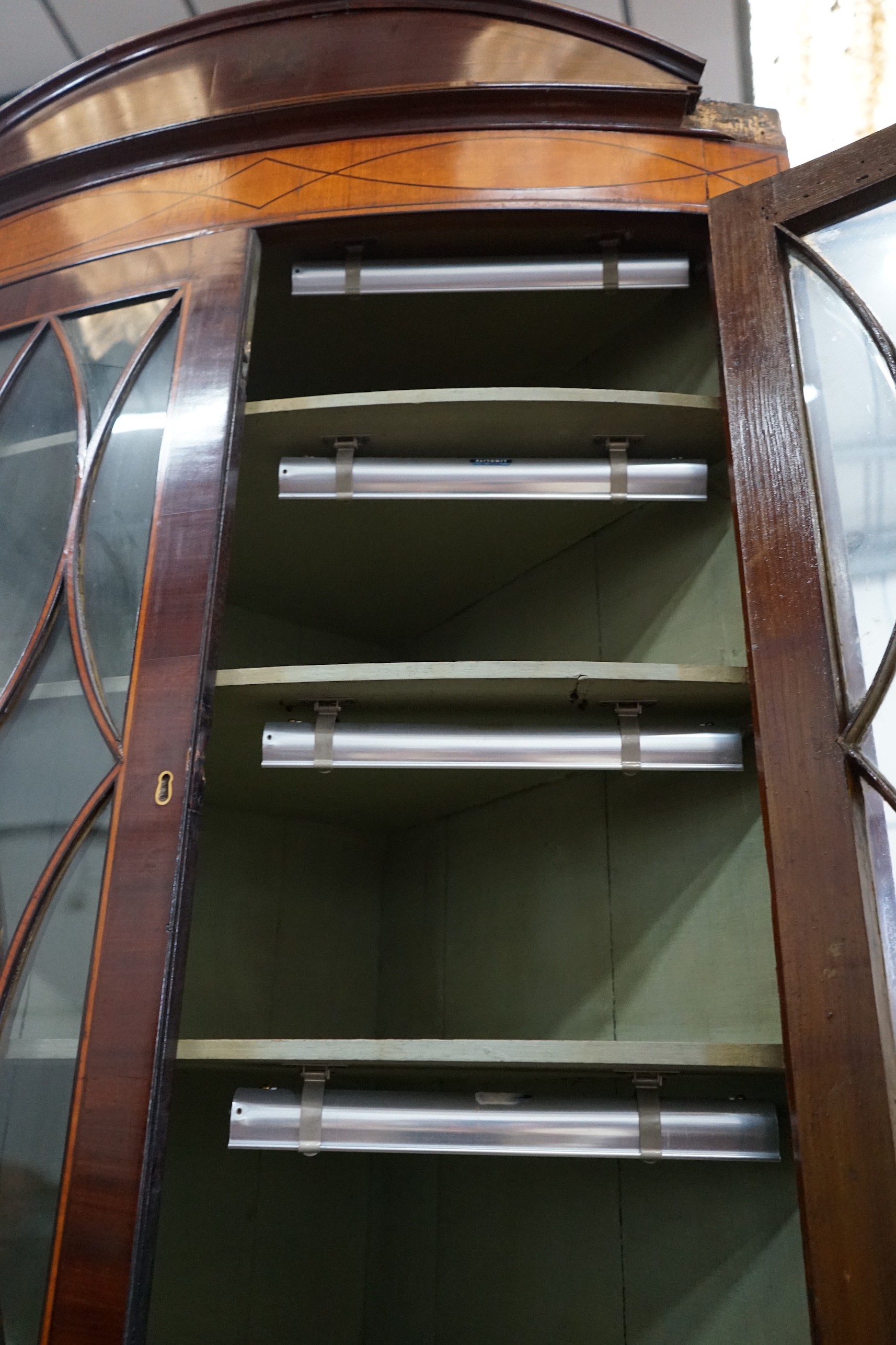 A large Regency mahogany bowfront standing corner cabinet, width 88cm, depth 47cm, height 246cm